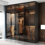AlUmaima Interiors luxury glass-front wardrobe with integrated LED rods in a modern Abu Dhabi executive suite.