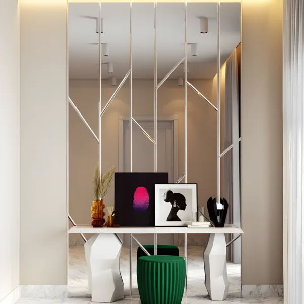 AlUmaima Interiors bespoke geometric mirror wall with a modern white console table and green ottoman in Abu Dhabi.