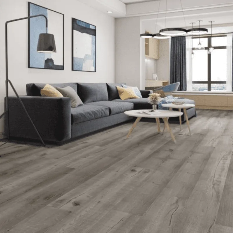 AlUmaima Interiors gray wide-plank parquet flooring in a modern Abu Dhabi residence with L-shaped sofa and artistic decor.